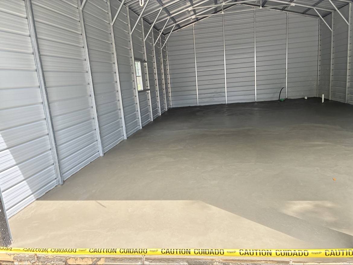 New smooth concrete floor inside a metal building