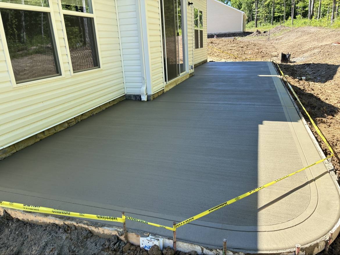 Fresh smooth concrete patio beside a house