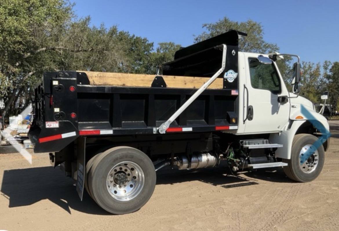 Reliable Excavating dump truck from the rear showing the black dump bed