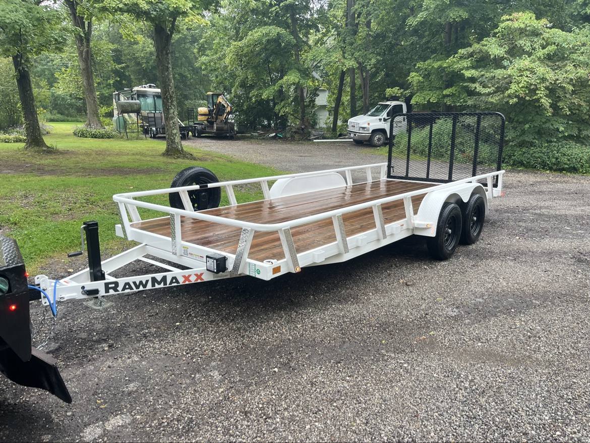 White tandem-axle equipment trailer with a wood deck